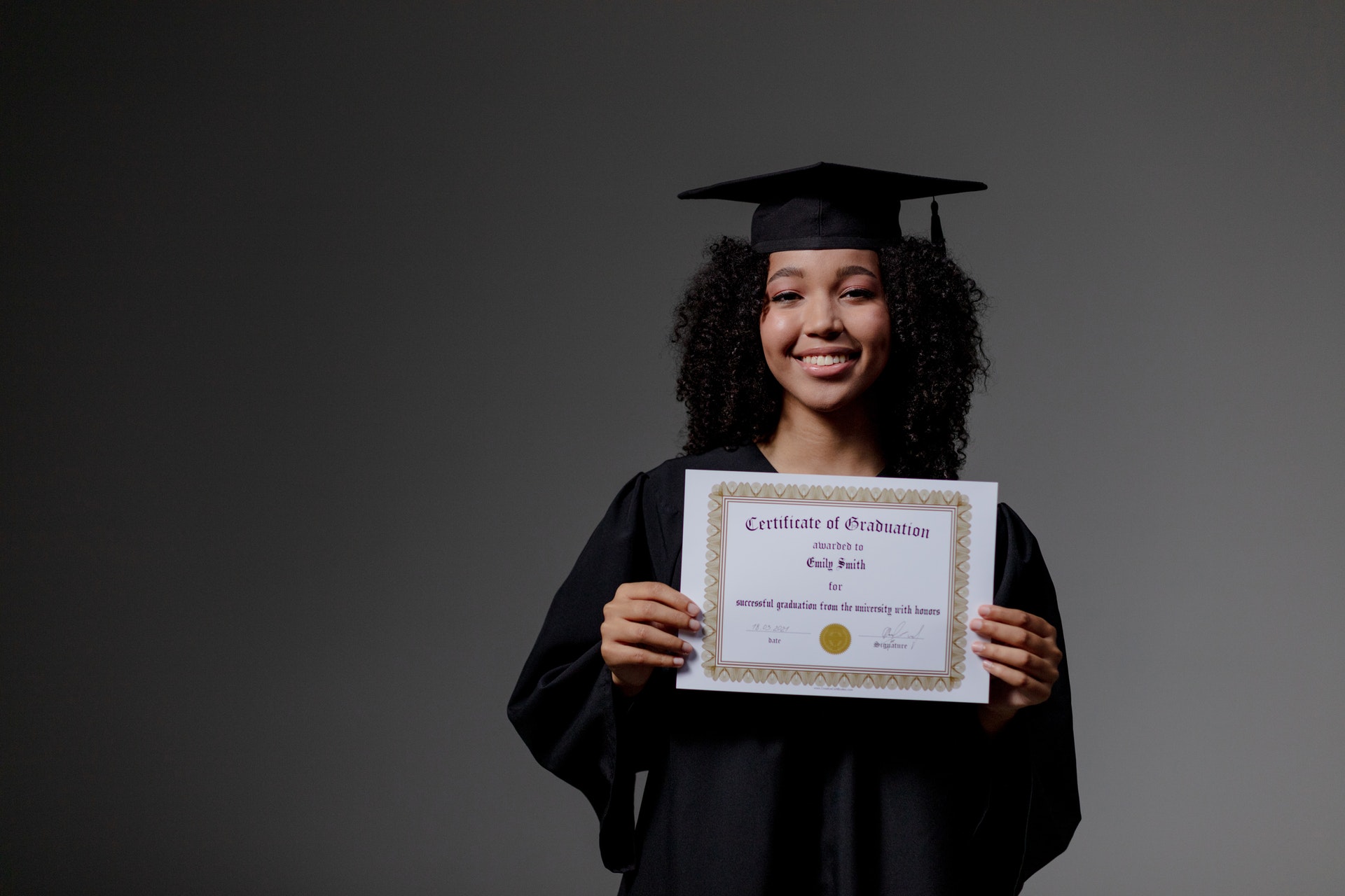 a female holding a certificate